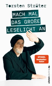 Cover von „Mach mal das große Leselicht an“: bärtiger Mann mit Beanie hebt Arm, weißer Hintergrund, Titel in grünen Balken.